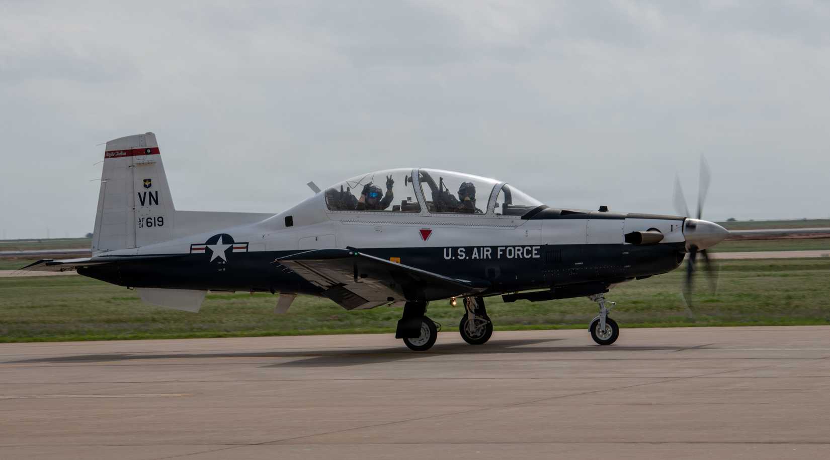 An instructor and student pilot taxi a T-6A Texan II toward the flightline on Vance Air Force Base