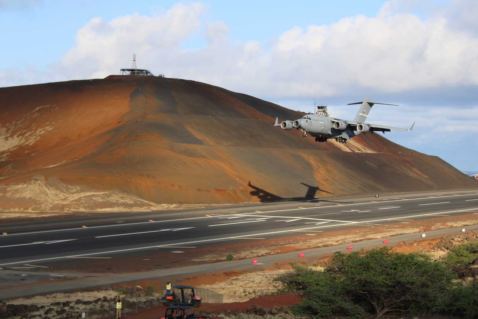 A C-17 Globemaster comes in to land on the newly completed eastern half of the runway on Ascension Island, 31 August 2022. Following the completion of the first half of the runway, the Air Force Civil Engineer Center is preparing to begin its work on the western half of the runway in the coming weeks. (U.S. Air Force by Mike Pawlus)
