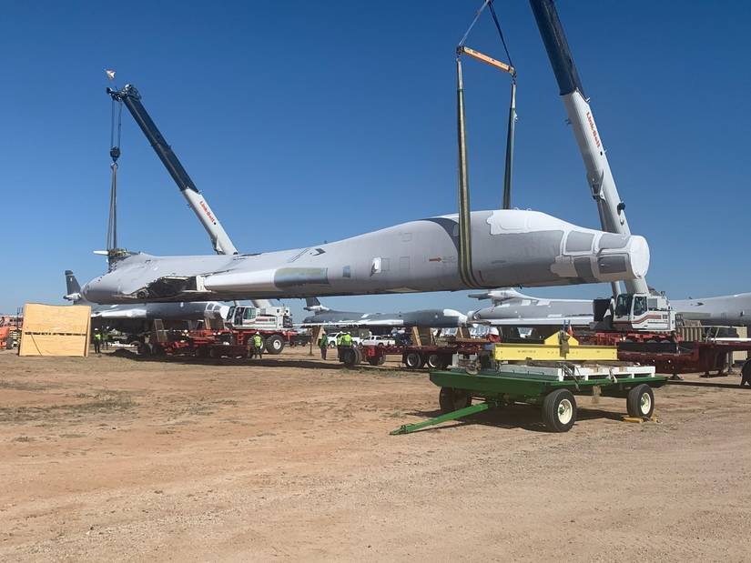 B-1B tail #85-0092 is lifted and placed on flatbed trailers for the 1,000 mile journey to Wichita, Kansas.