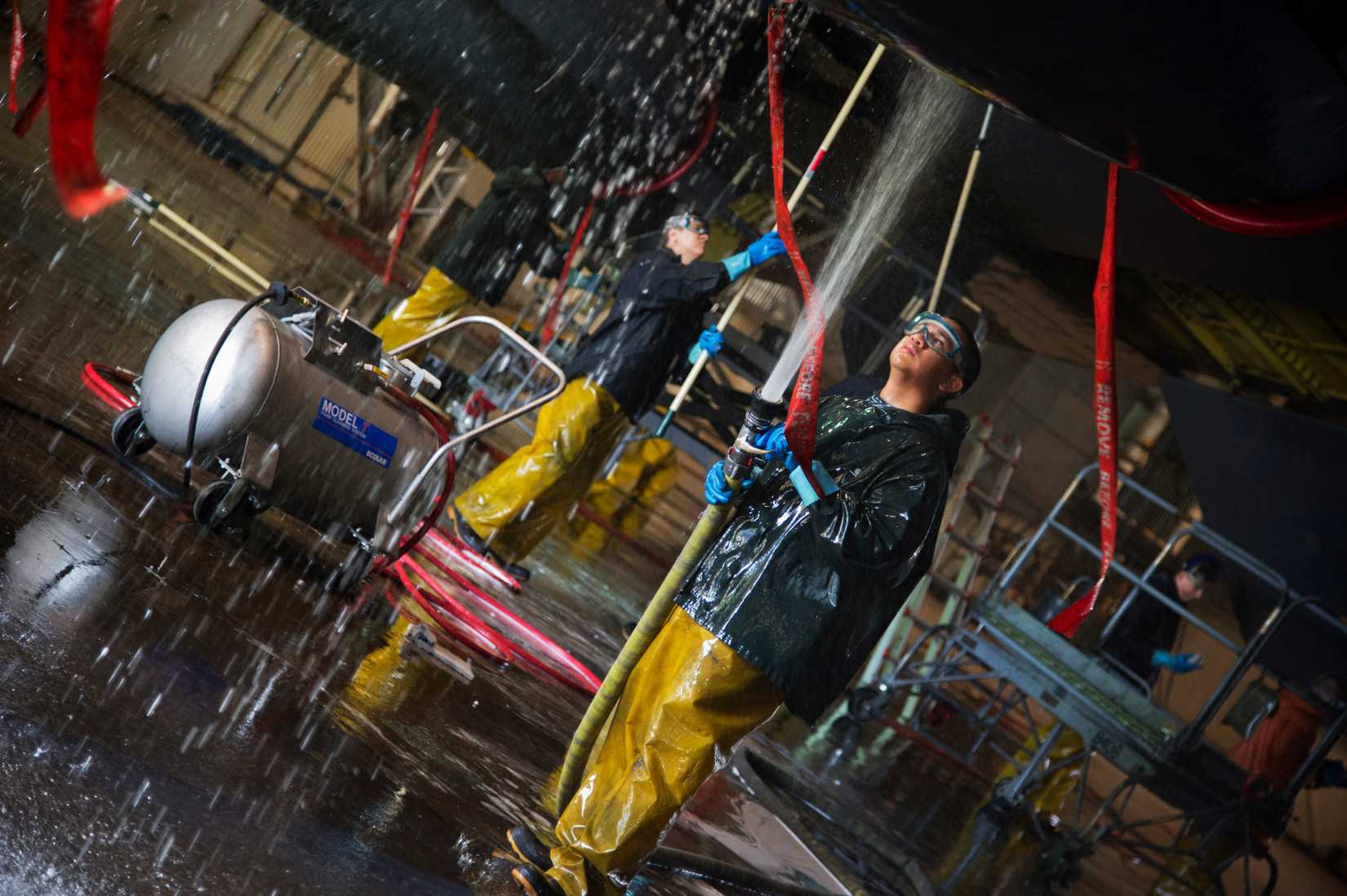 irmen from the 5th Aircraft Maintenance Squadron wash a B-52H Stratofortess at Minot Air Force Base, N.D., June 19, 2013. After the wash is completed, the post wash lube is used to force water and collected dirt out of high friction and moving areas. This keeps the parts functioning properly for safety during flight. (U.S. Air Force photos/Senior Airman Brittany Y. Auld)