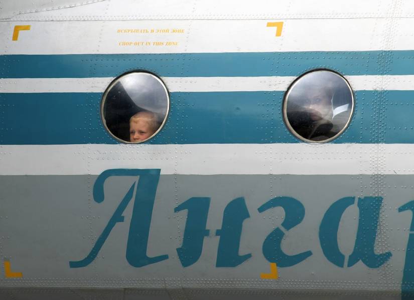 Boy_looks_out_of_the_window_of_an_Angara_Airlines_Antonov_An-24RV_at_Irkutsk_Airport