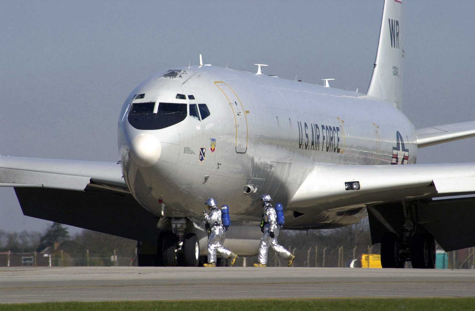 Firefighters assigned to the 100th Civil Engineer Squadron (CES), walk around an E-8C Joint Surveillance Target Attack Radar System (JSTARS) aircraft after it landed at Royal Air Force (RAF) Mildenhall
