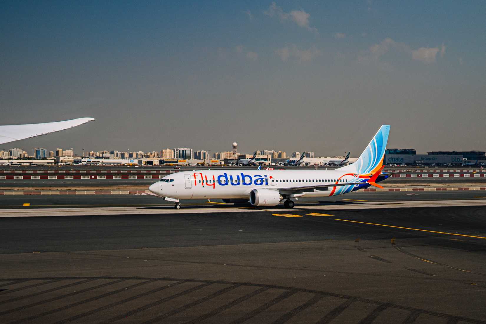 FlyDubai aircraft on the runway at Dubai International Airport