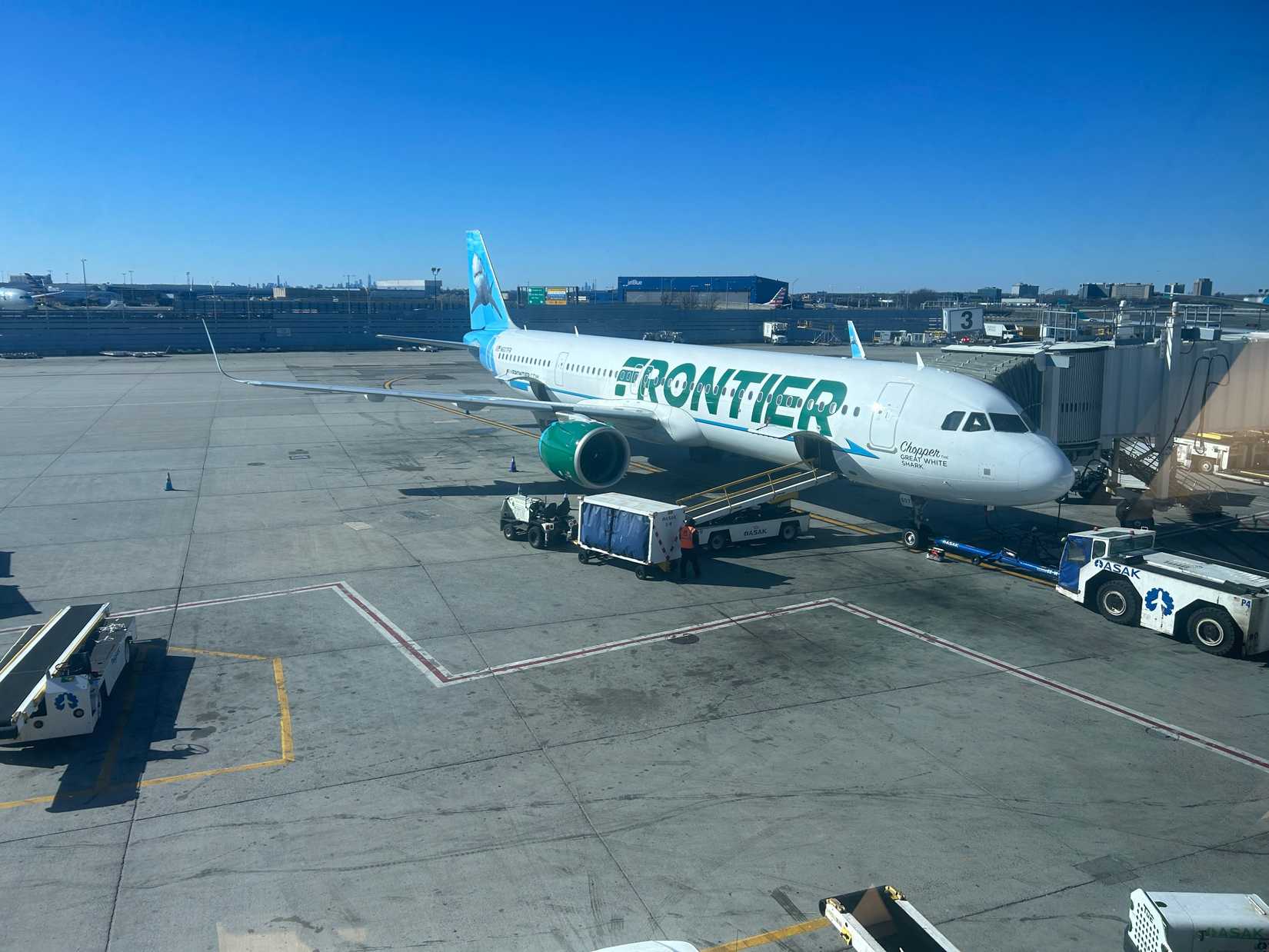 Frontier Airlines parked blue sky