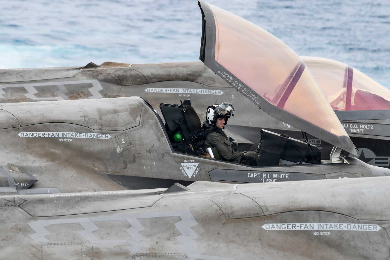 Marine assigned to Marine Fighter Attack Squadron (VMFA) 122, 11th Marine Expeditionary Unit, sits in the cockpit of an F-35B Lightning II on the flight deck