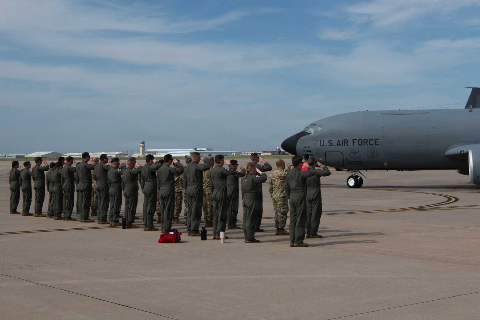 Members of the 350th Air Refueling Squadron salute a KC-135 Stratotanker
