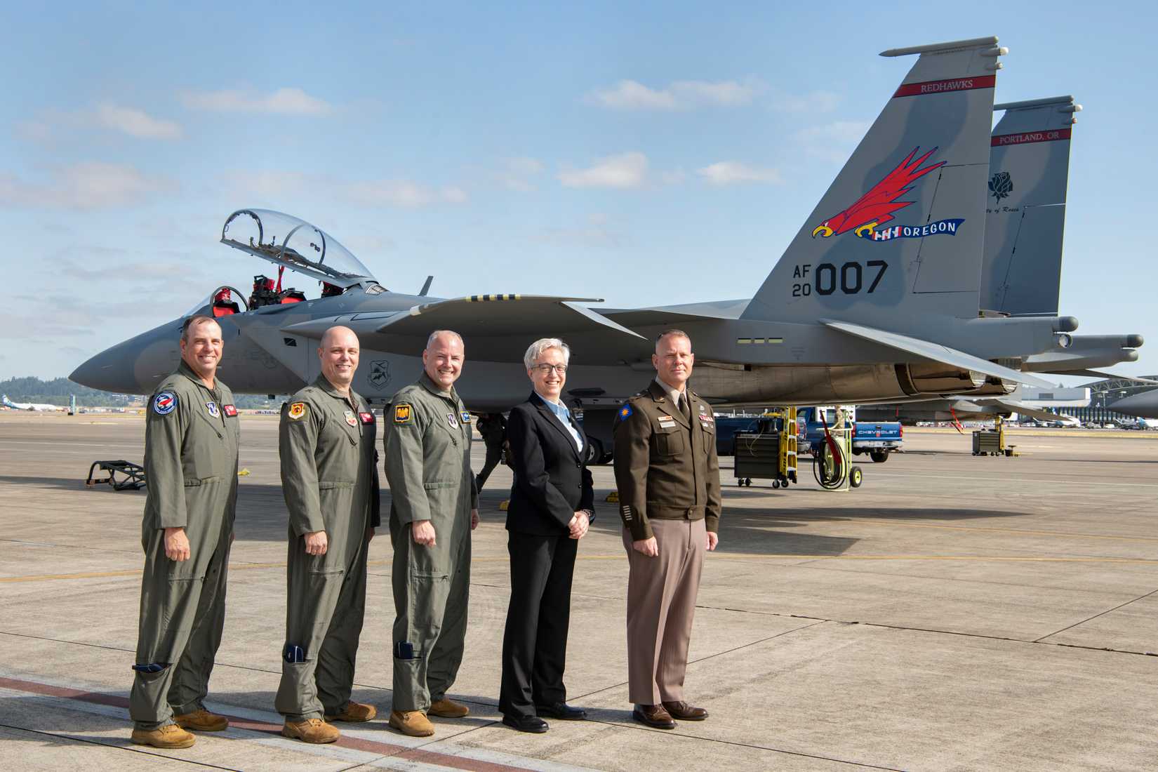 Oregon's Governor and Oregon Air National Guard leaders gather for a group photo with the new F-15EX Eagle II fighter jet prior to the official Unveiling Ceremony at the 142nd