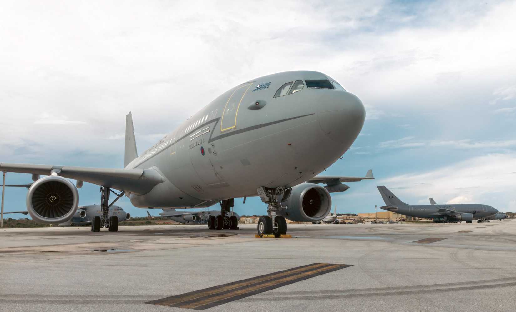 An up-close photo of a Voyager tanker aircraft parked on the tarmac, with another in the background.