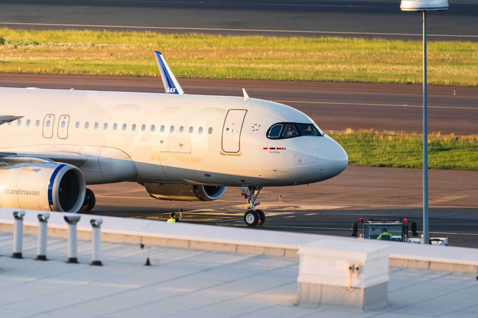 SAS Airbus A320neo taxing green grass