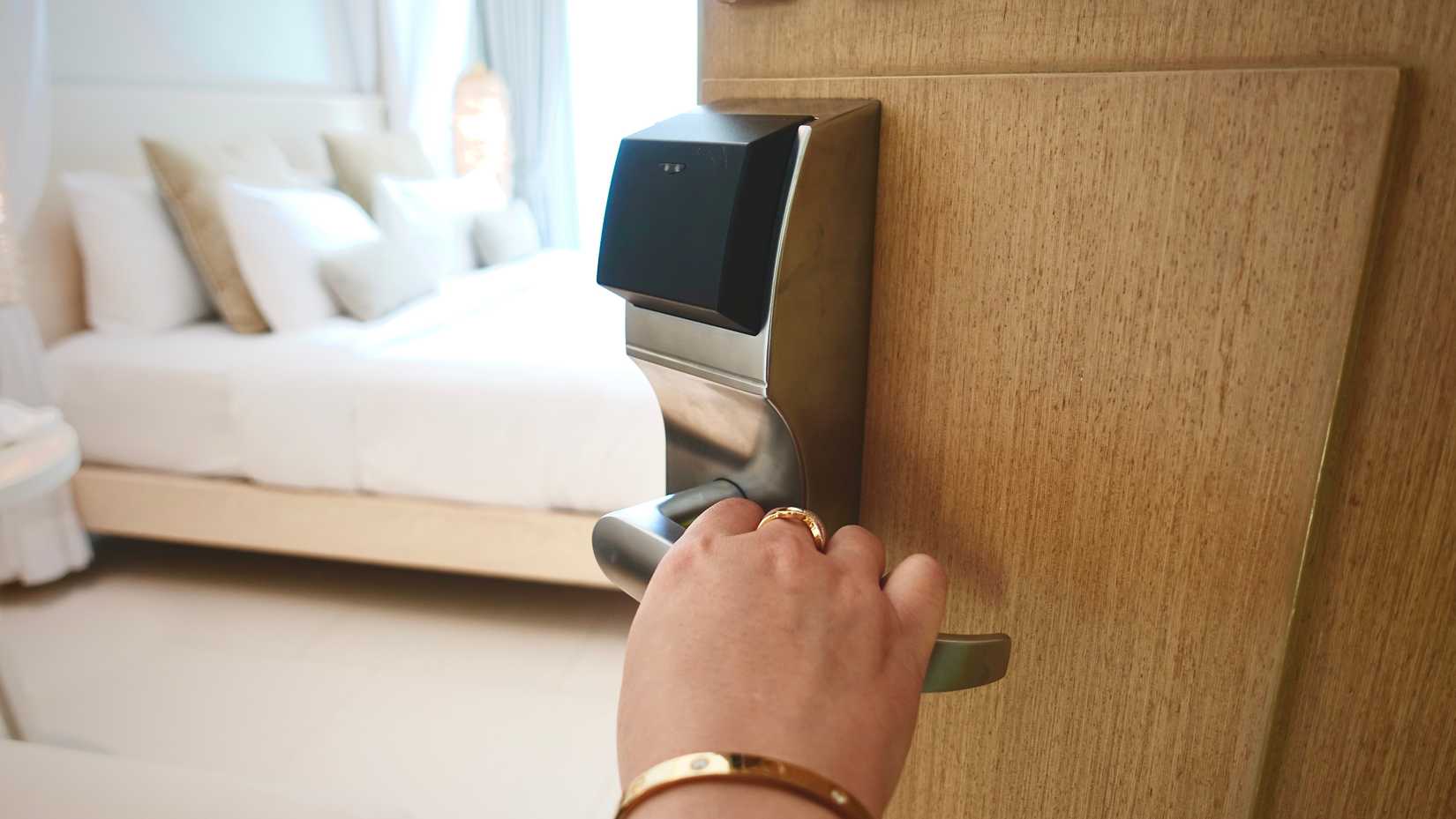 a person opening a hotel room door