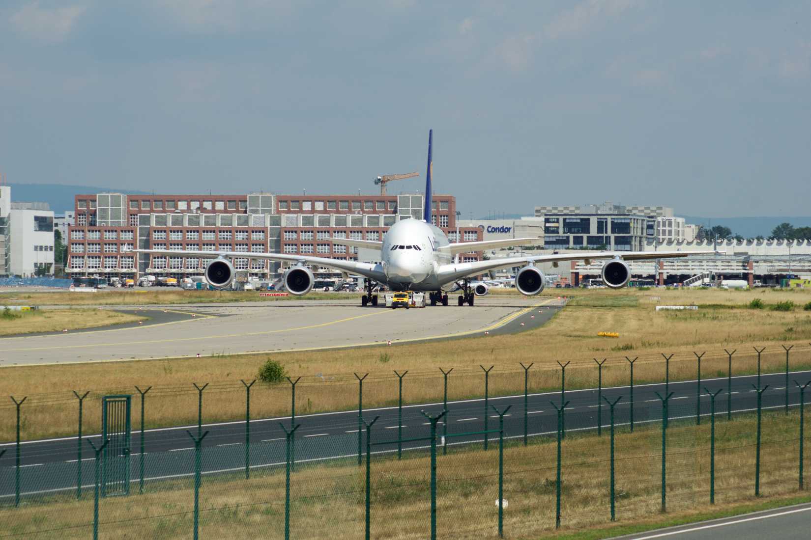 Airbus A380 of Lufthansa with registration D-AIMH moves on taxiway by tow truck before departure from FRA airport shutterstock_1298798473