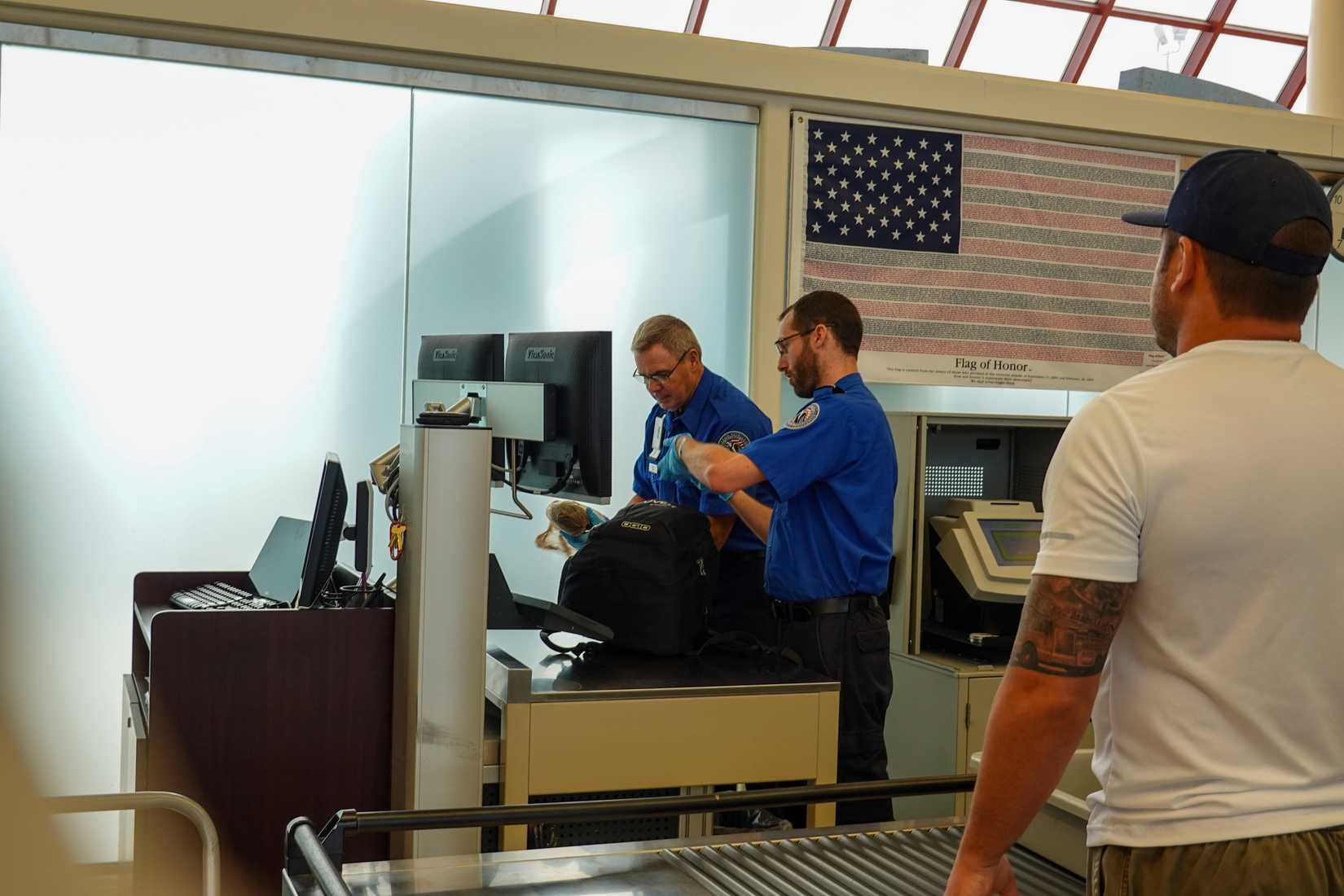 TSA Officers Looking At Bag