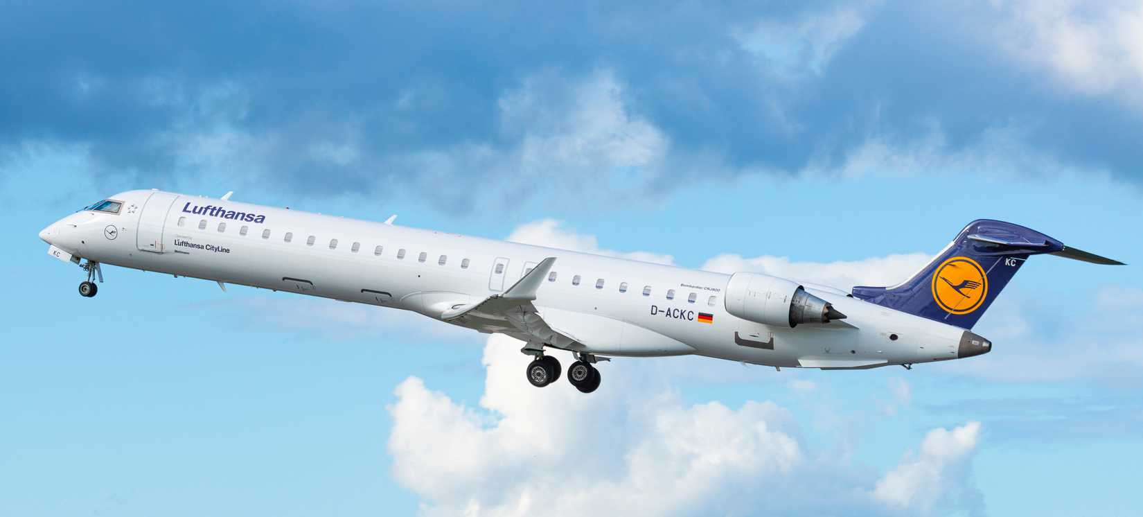 GDANSK, POLAND - SEPTEMBER 28, 2018: German airlines Lufthansa CityLine branded Bombardier CRJ-900 jet airplane flying in the air on blue sky from Lech Walesa International Airport in Gdansk.