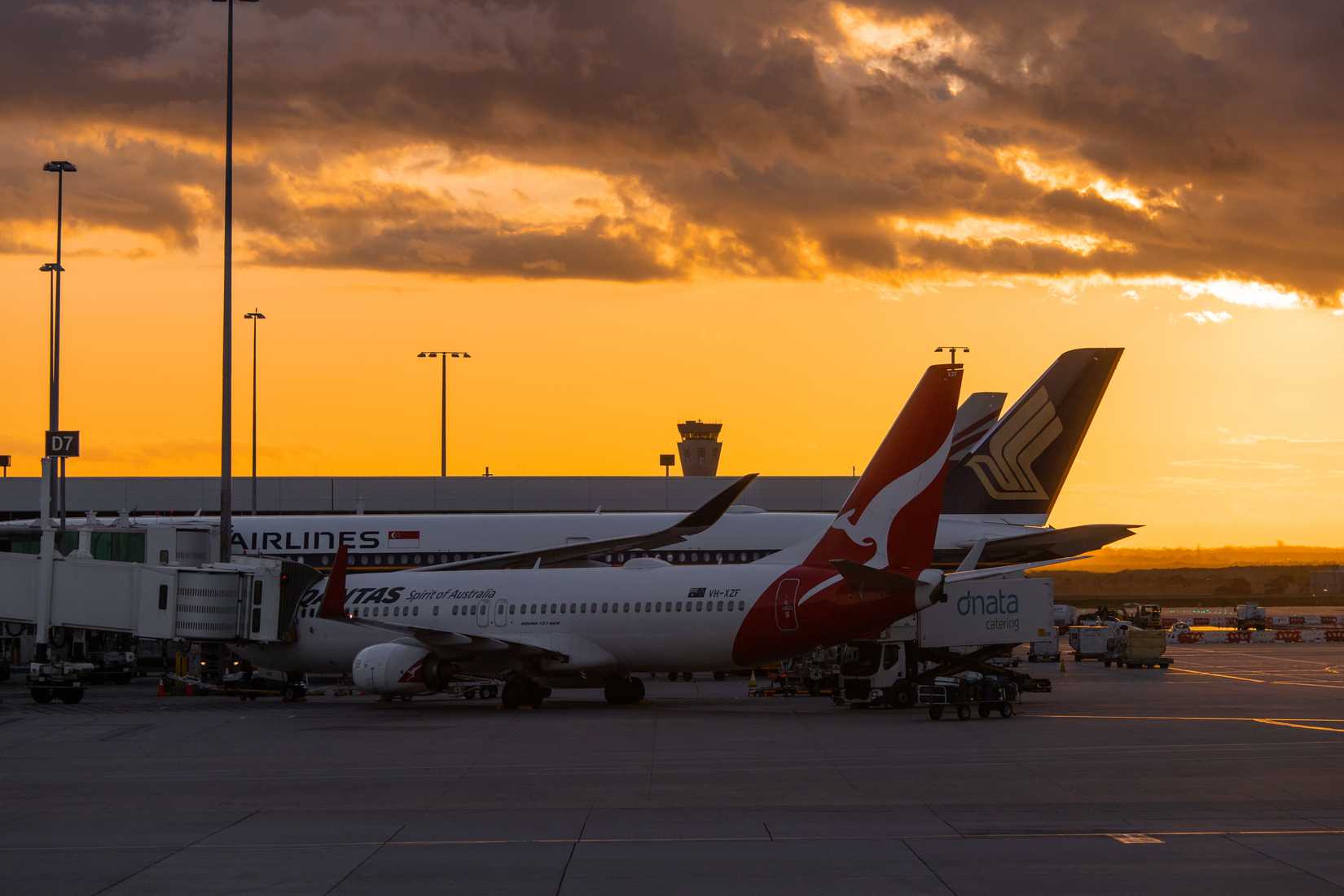 Melbourne, Australia - September 30, 2022: Qantas Boeing 737 and Singapore Airlines Airbus A350 at the gate.