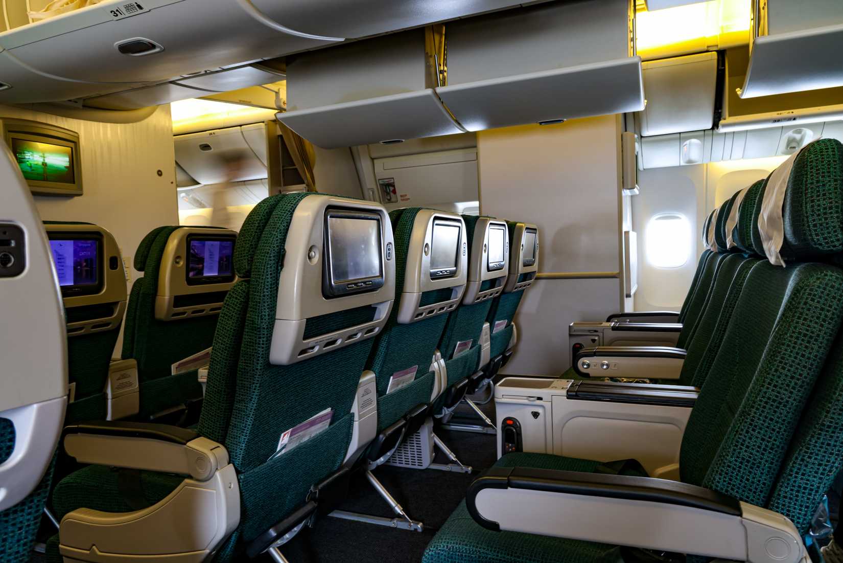 SINGAPORE - 31 MAY 2023: The Premium Economy seats of Cathay Pacific Boeing 777  offer a greater sense of personal space and seclusion. There is the state-of-the-art 15.6-inch 4K widescreen. 