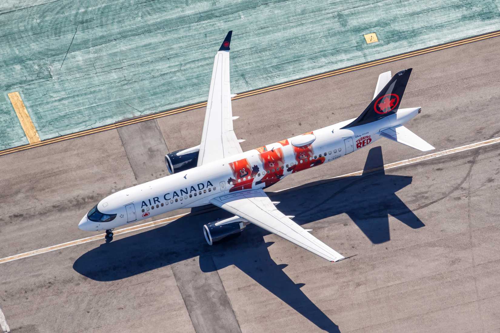 Los Angeles, United States - November 4, 2022: Air Canada Airbus A220-300 airplane with Turning Red special livery at Los Angeles Airport (LAX) aerial view in the United States.