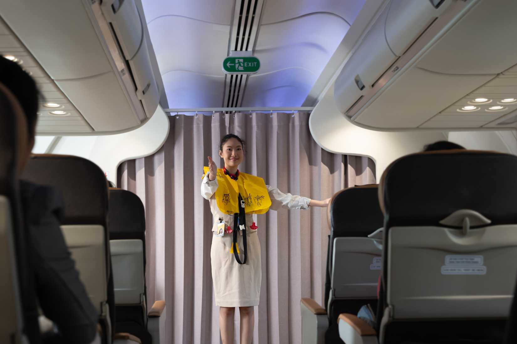 flight attendant safety demonstration with lifejacket