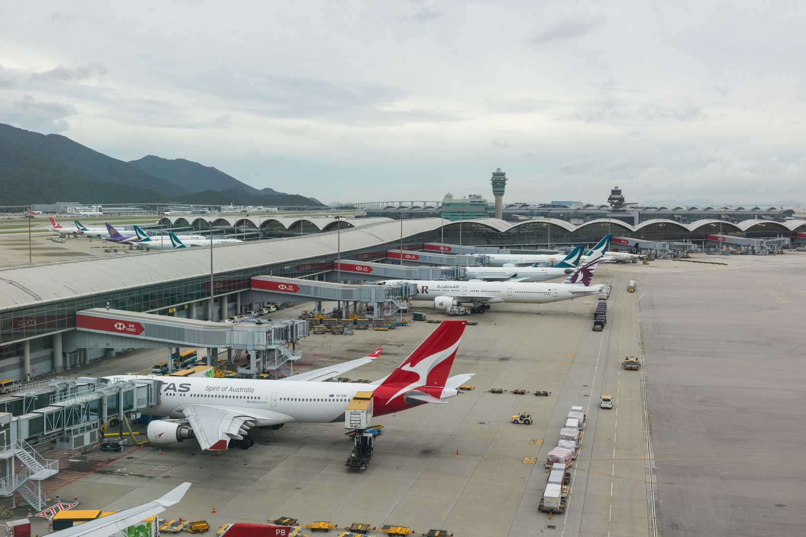 Hong Kong 25 August 2025 : Large Airplane Resting on Hong Kong Airport Tarmac Near Terminal
