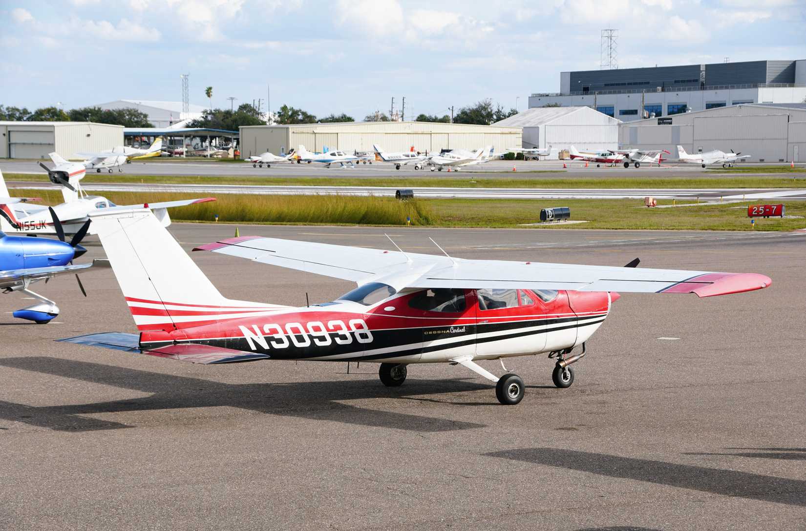 St Petersburg, Florida, U.S.A - Jan 2, 2025 - A red and white Cessna Cardinal parked on the ramp at Albert Whitted Airport
