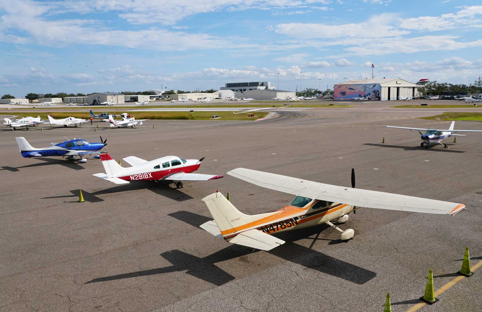 St Petersburg, Florida, U.S.A - Jan 2, 2026 - General aviation aircraft, including Cessnas and Beechcrafts, parked on the sunny tarmac at Albert Whitted Airport