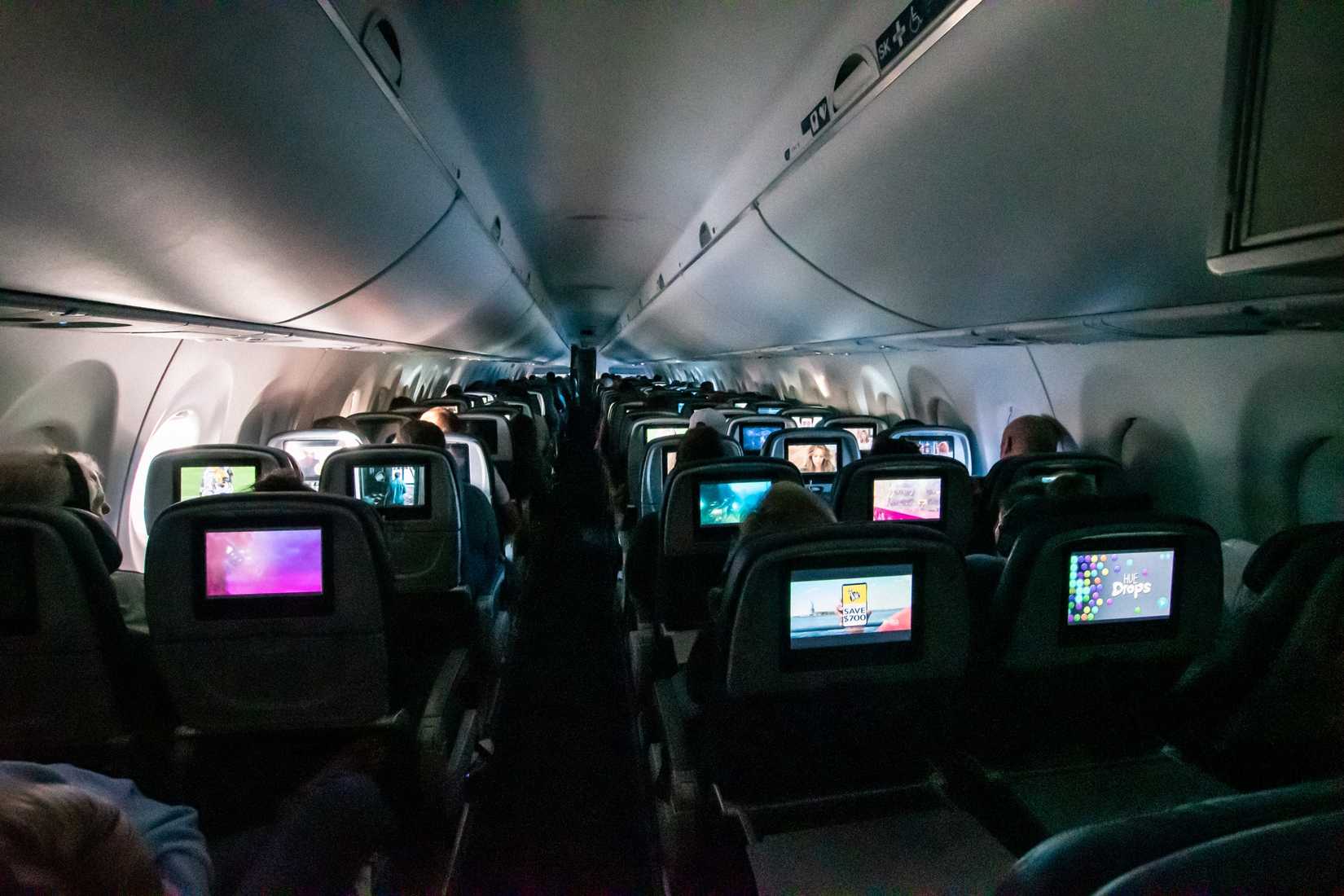 Somewhere Over Nevada, USA - September 30, 2023 - Peering Up the Delta Air Lines Airbus A220-100 Cabin  This look is inside an Airbus A220-100 from the rear of the cabin looking forward in mid-flight. Delta Air Lines has configured their Airbus A220-100 cabins into a three-class configuration of 12 for First Class, 20 for Delta Comfort and 77 for Main Cabin for a total of 109 leather seats. 