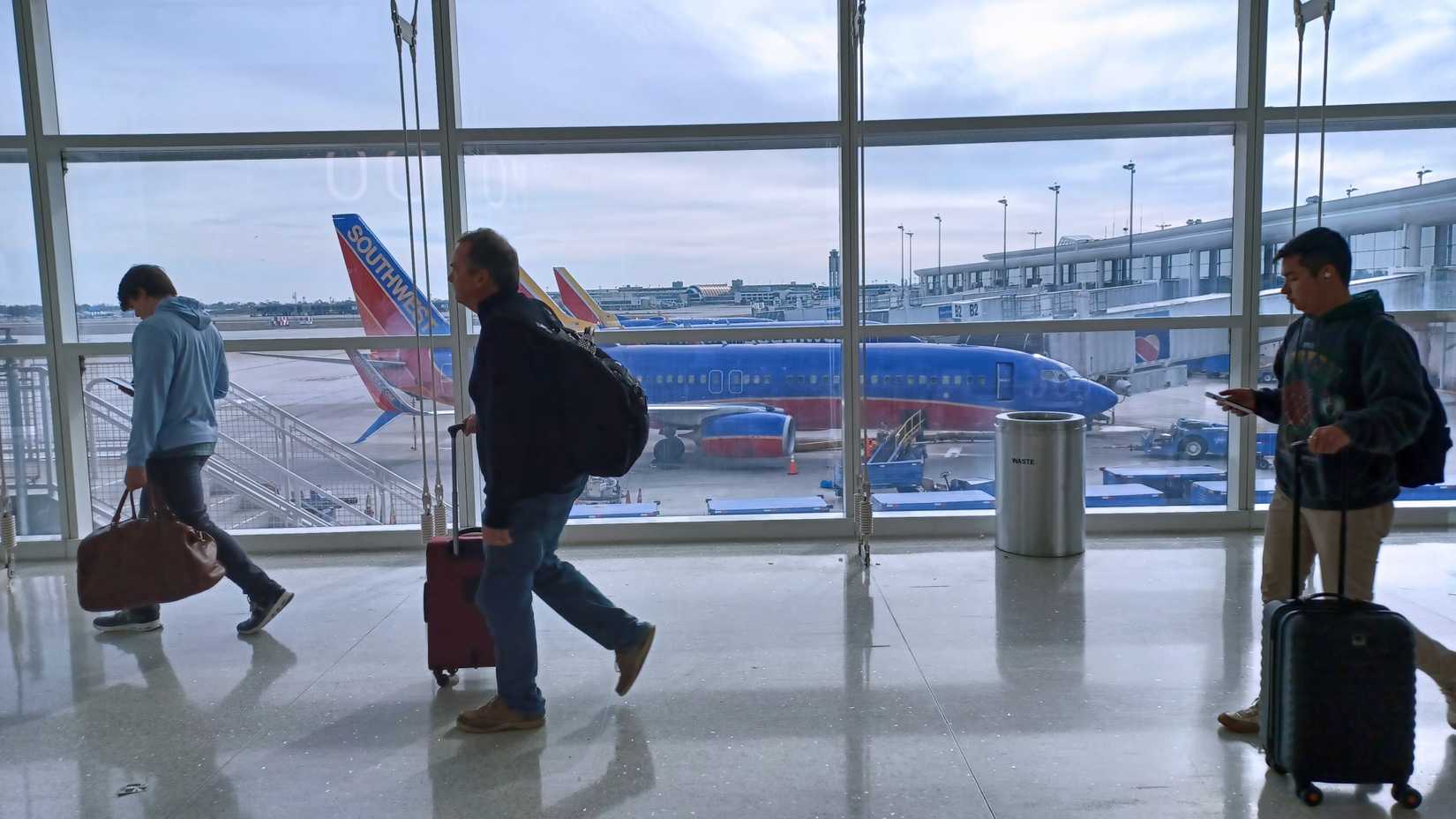 Passengers in the boarding area; Southwest aircraft in the background
