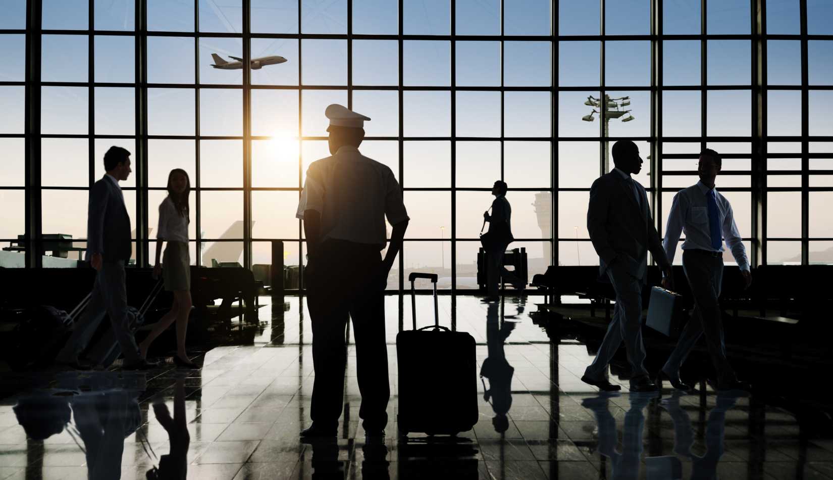Back Lit Business People and a Pilot Traveling Airport Passenger Concept