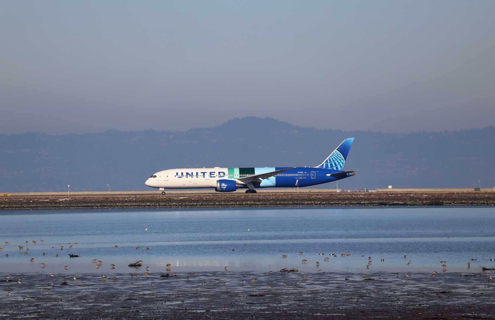 United Airlines Boeing 787-9 Dreamliner featuring the special The Future is SAF livery, rolling down the runway at SFO