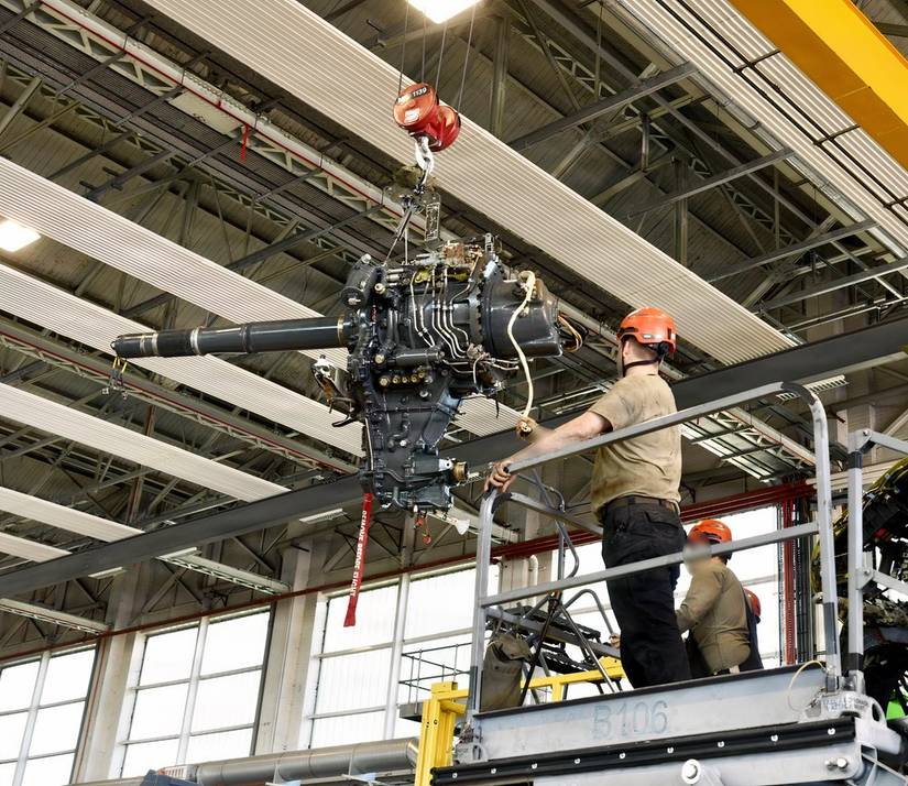 A photo of technicians performing repair or replacement on the V-22 gearbox.