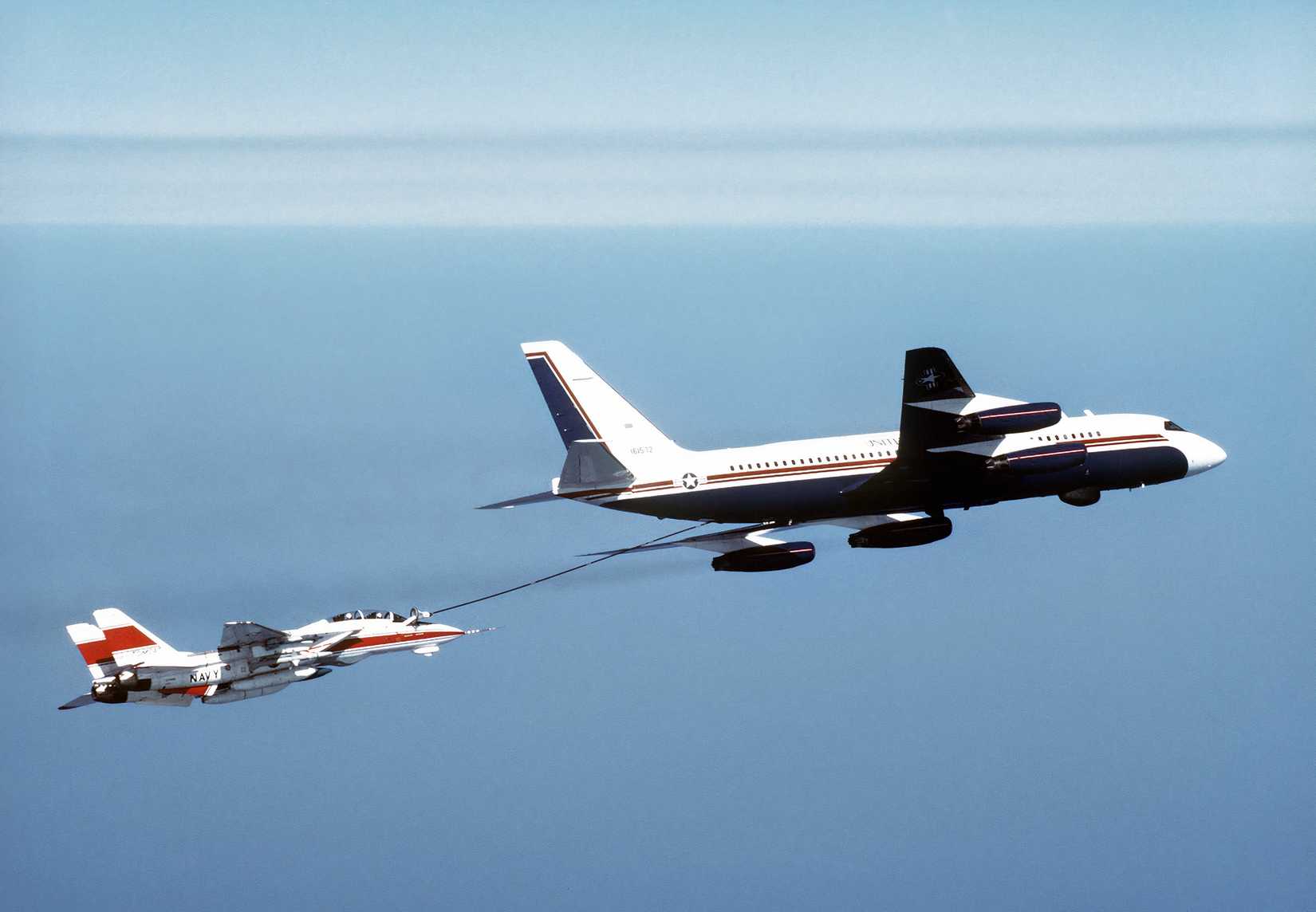A US Navy Convair UC-880 aircraft, refuels an F-14D Tomcat aircraft.