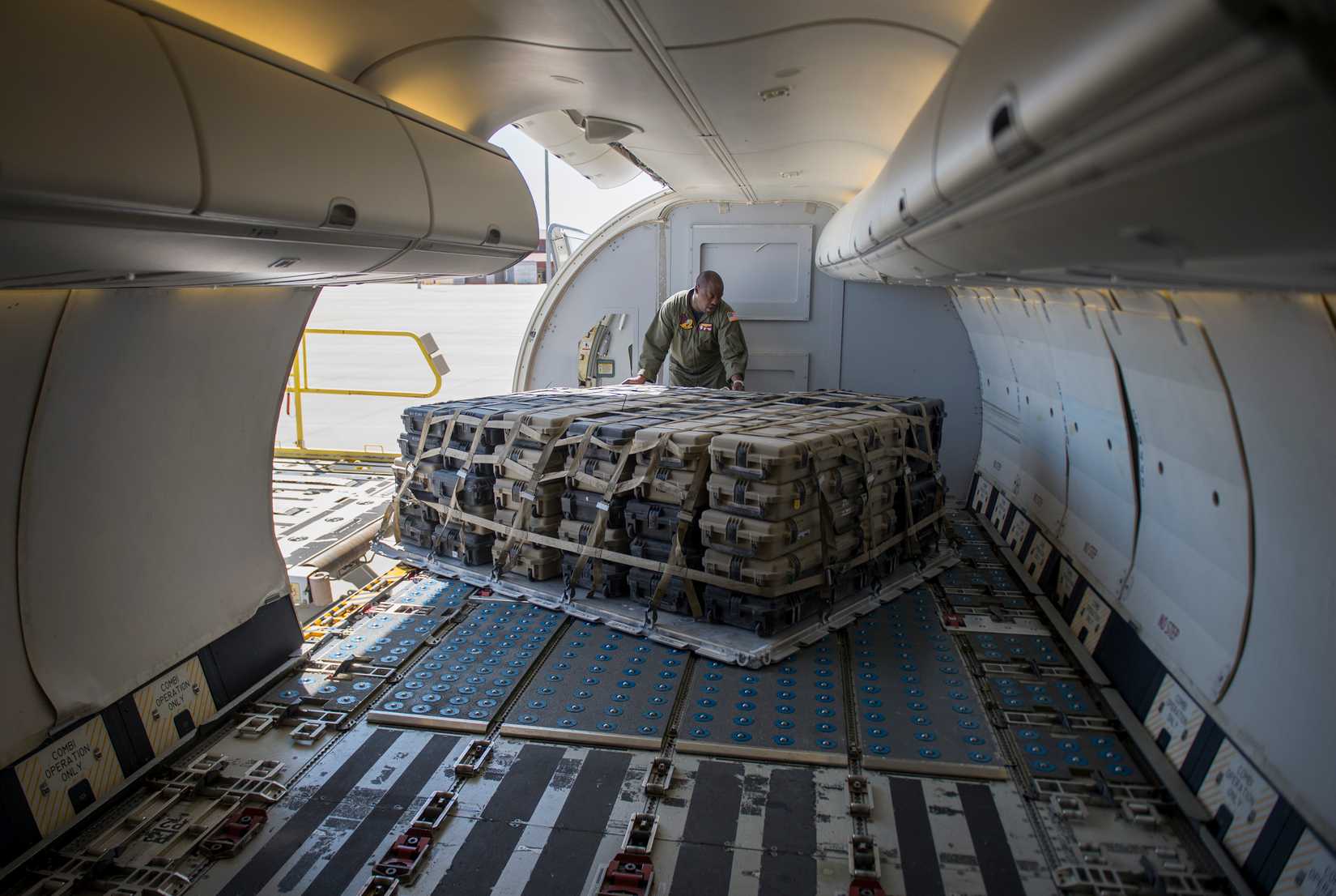 2nd Class Fred Johnson, a loadmaster assigned to Fleet Logistics Support Squadron (VRC) 57, loads a cargo pallet onto a C-40A Clipper at Biggs Army Airfield.