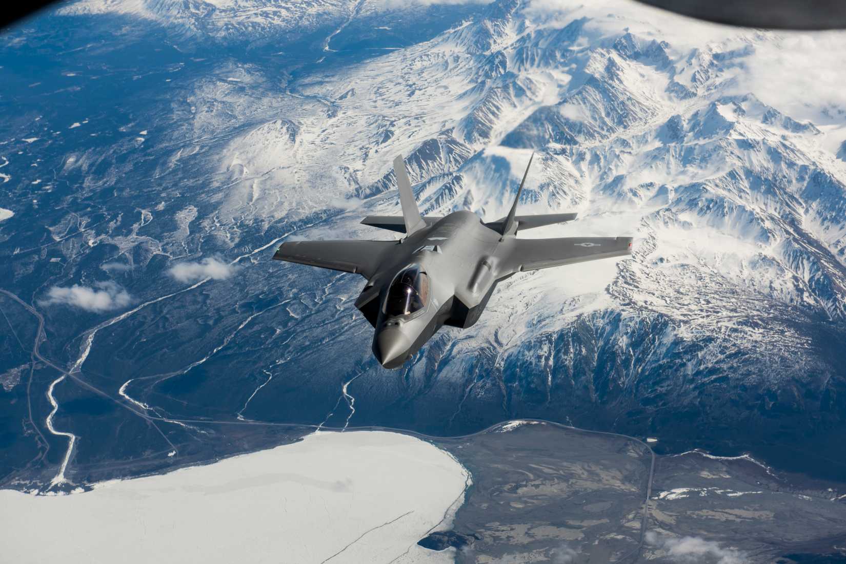 A new F-35A Lightning II fifth-generation fighter aircraft flies over the Alaska Canada Highway