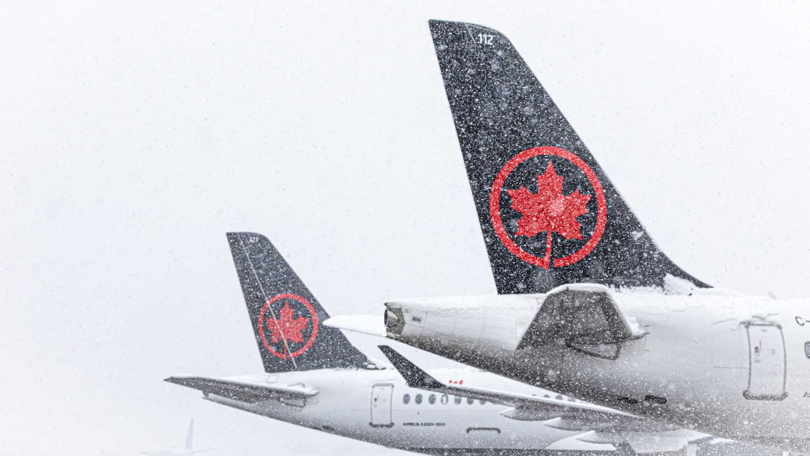 Air Canada jets parked in the snow at Denver International