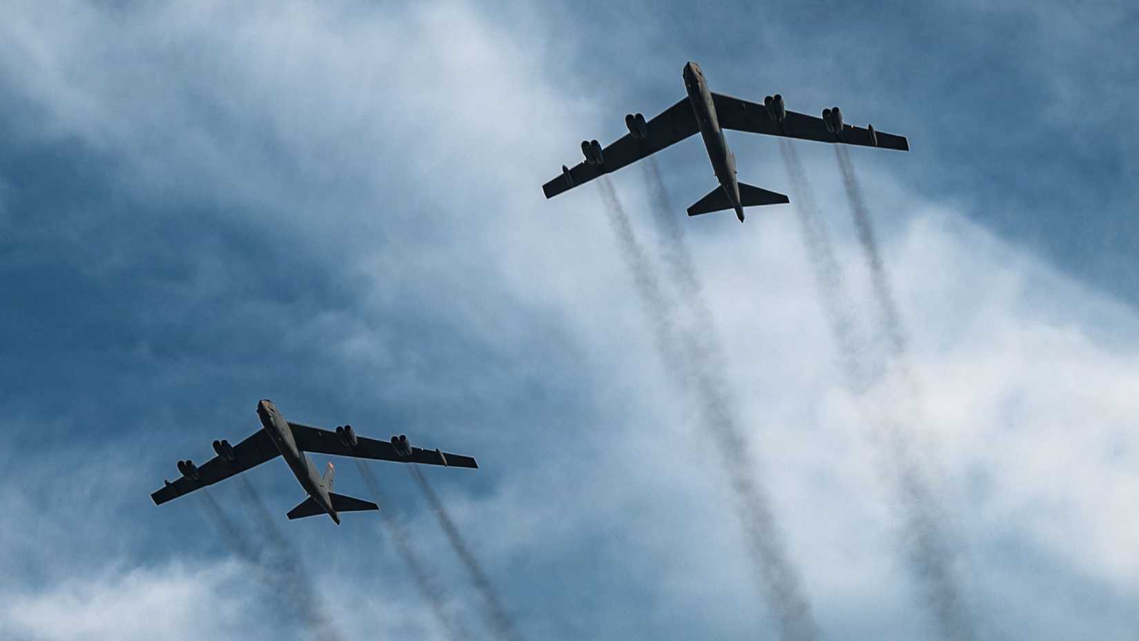 Air Force B-52H Stratofortresses assigned to the 5th Bomb Wing fly over