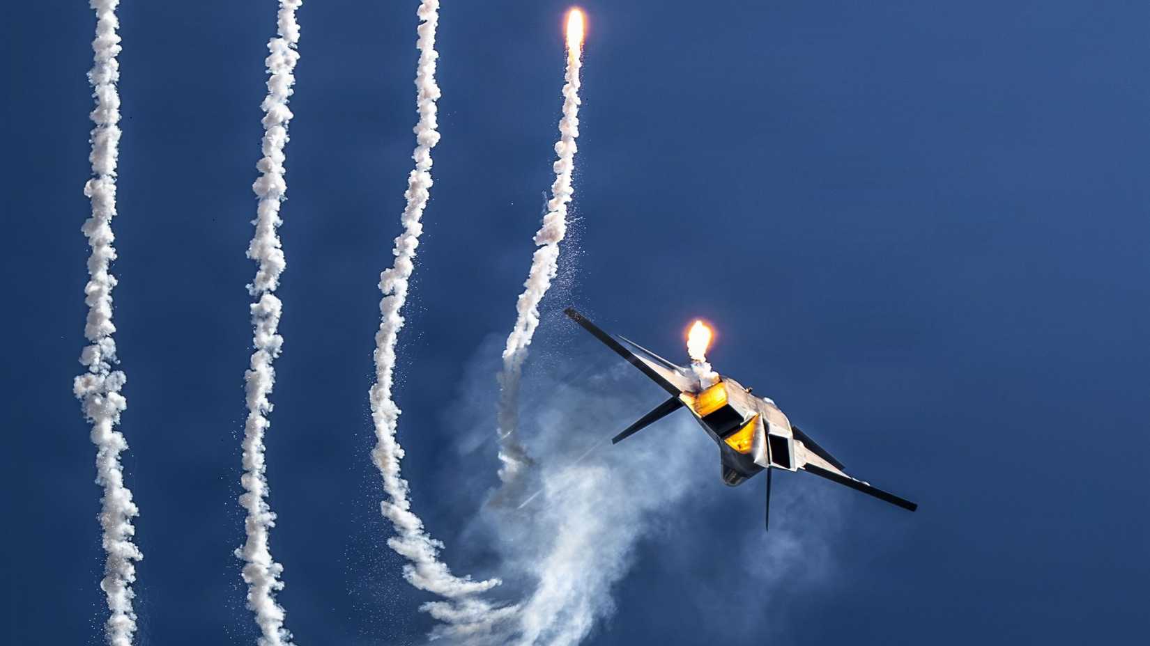Air Force F-22 Raptor deploys flares during an aerial demonstration at the 2026 Pacific Airshow