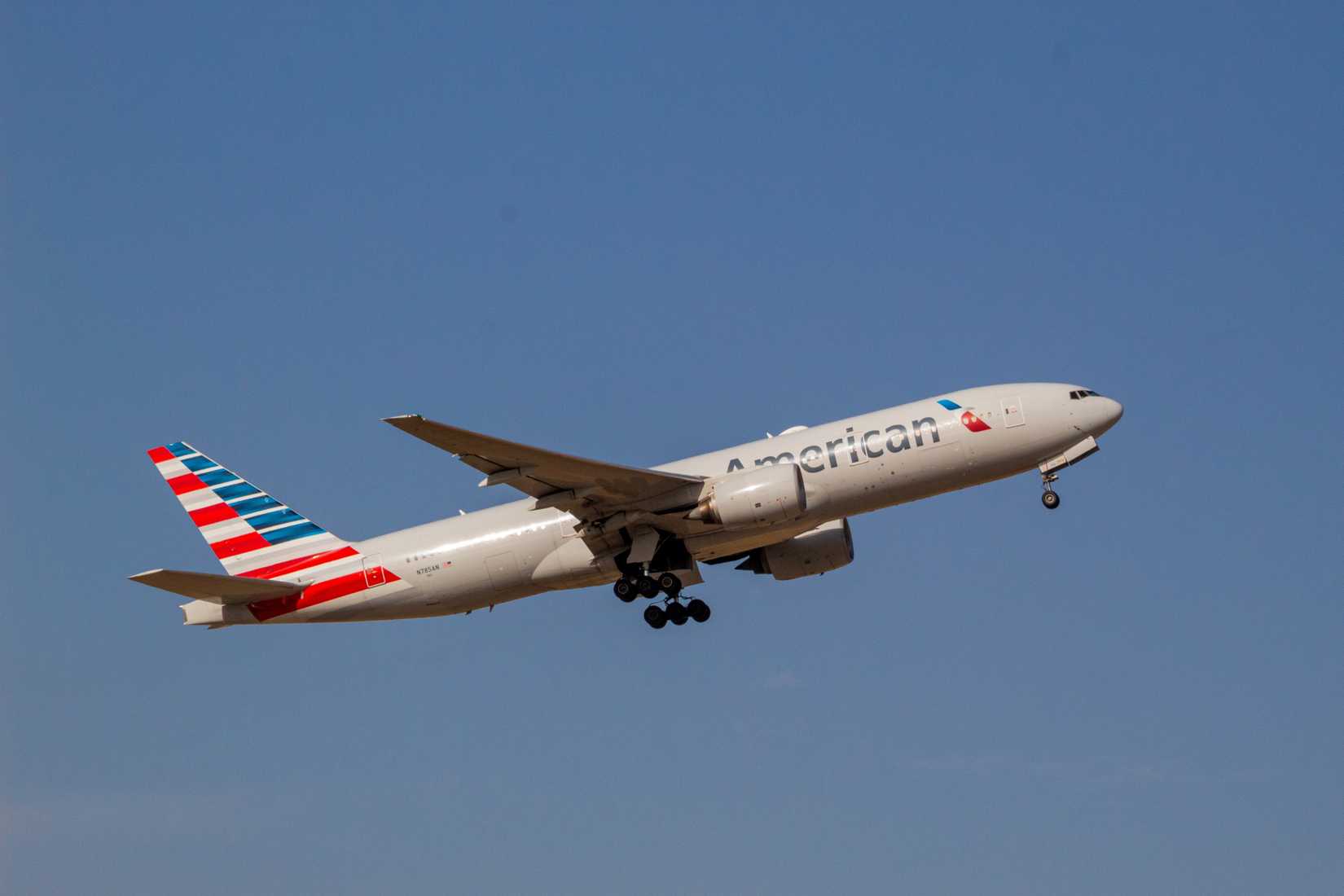 American Airlines Boeing 777-200ER takeoff blue sky