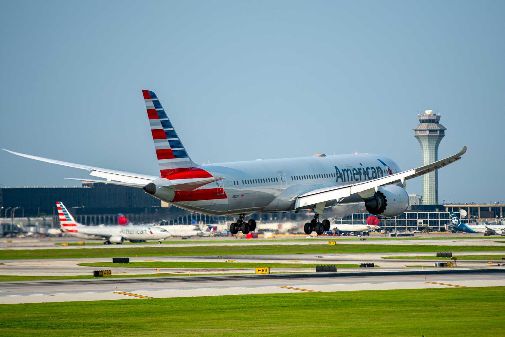 American Airlines Boeing 787-9 landing green grass