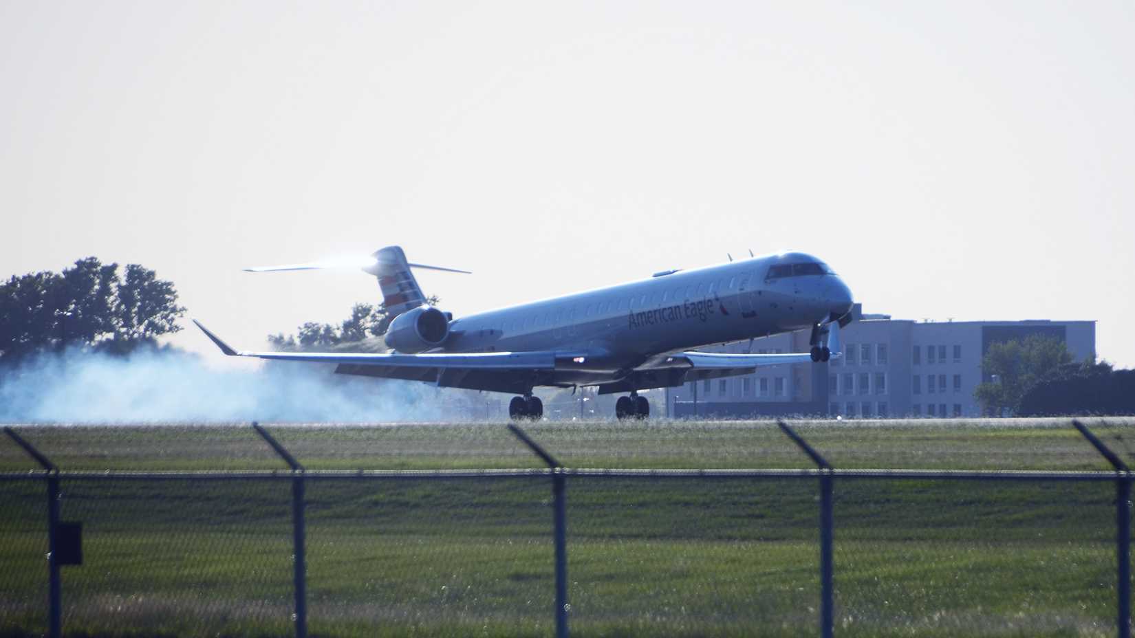 American Eagle Bombardier CRJ-900 landing with smoke