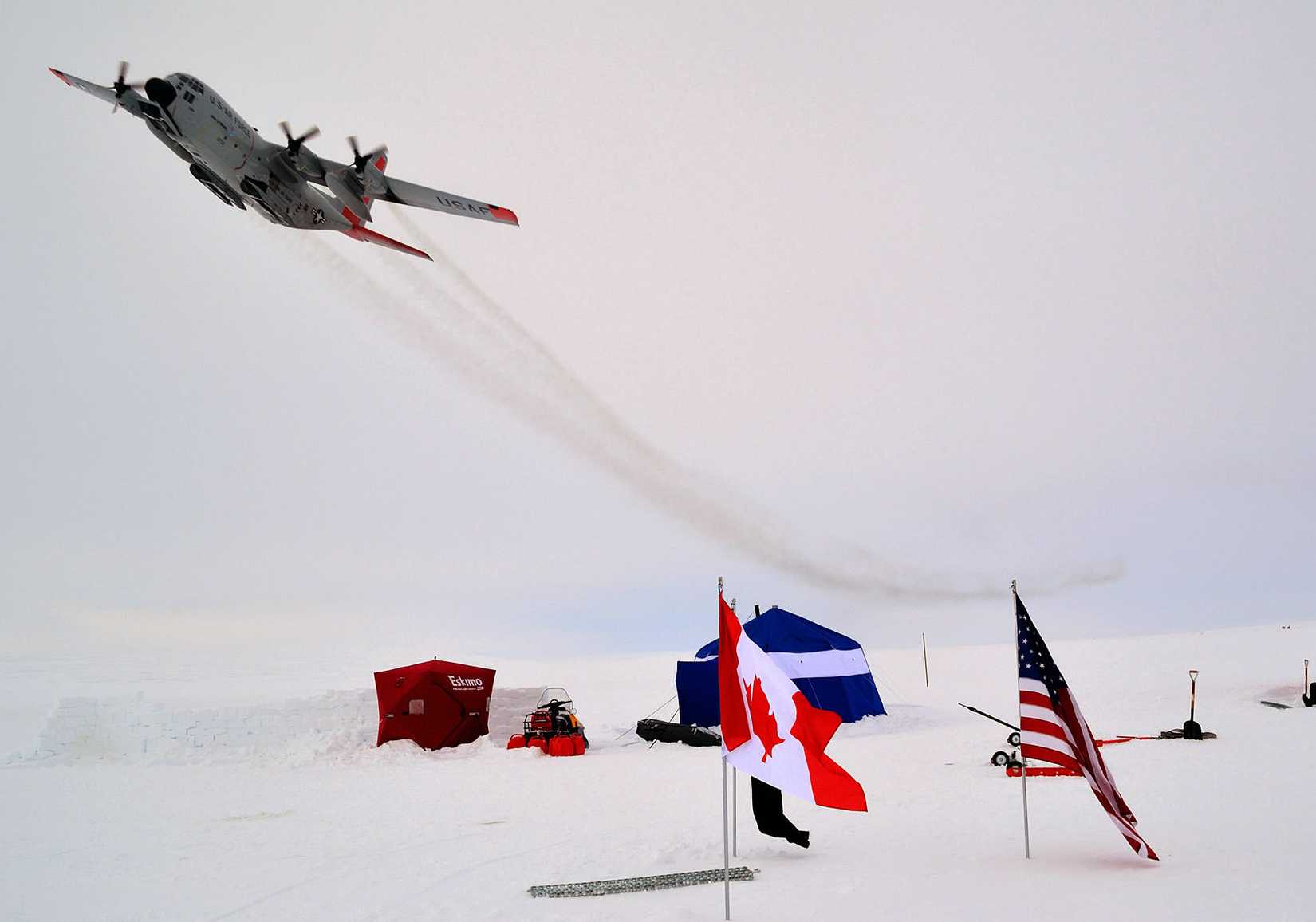An LC-130 belonging to the New York Air National Guard's 109th Airlift Wing flies over Ice Camp one on Sherard Osborne Island, Nunavut