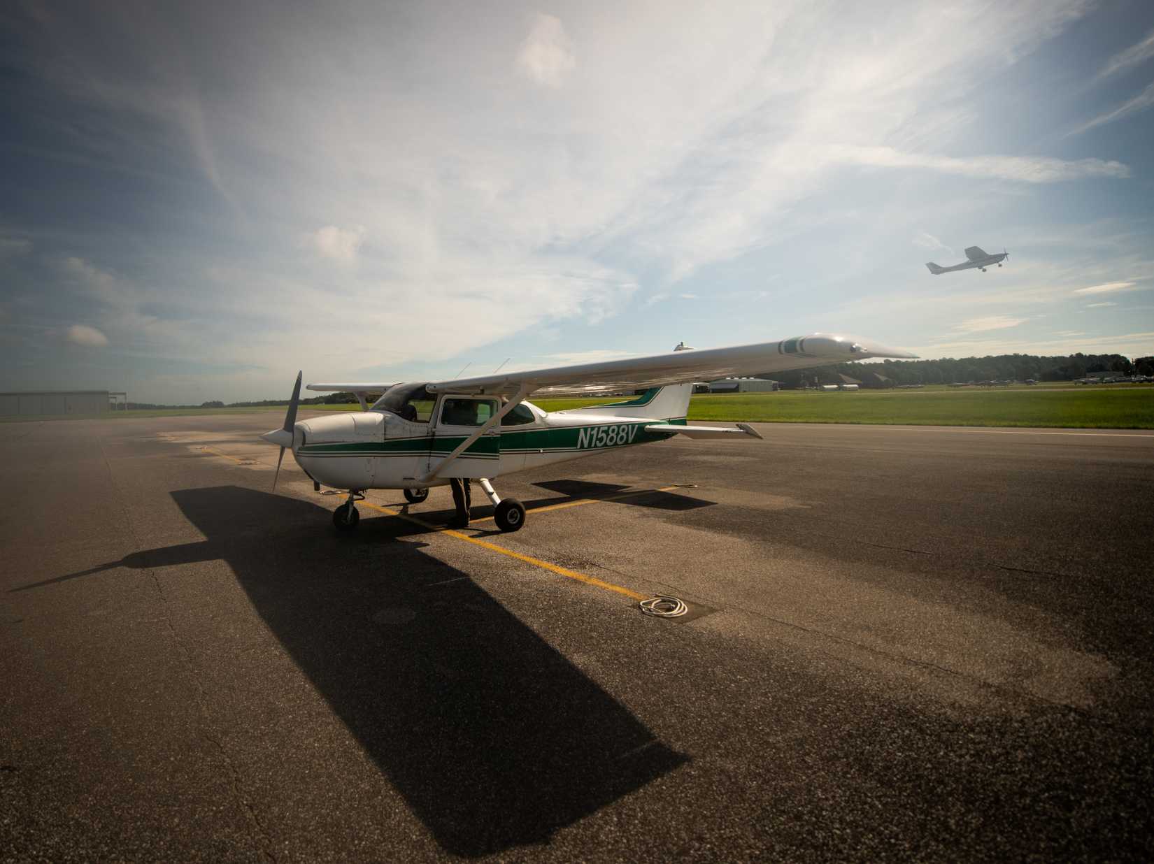 Cessna Plane ready for the students to fly, while a student practices takeoffs.