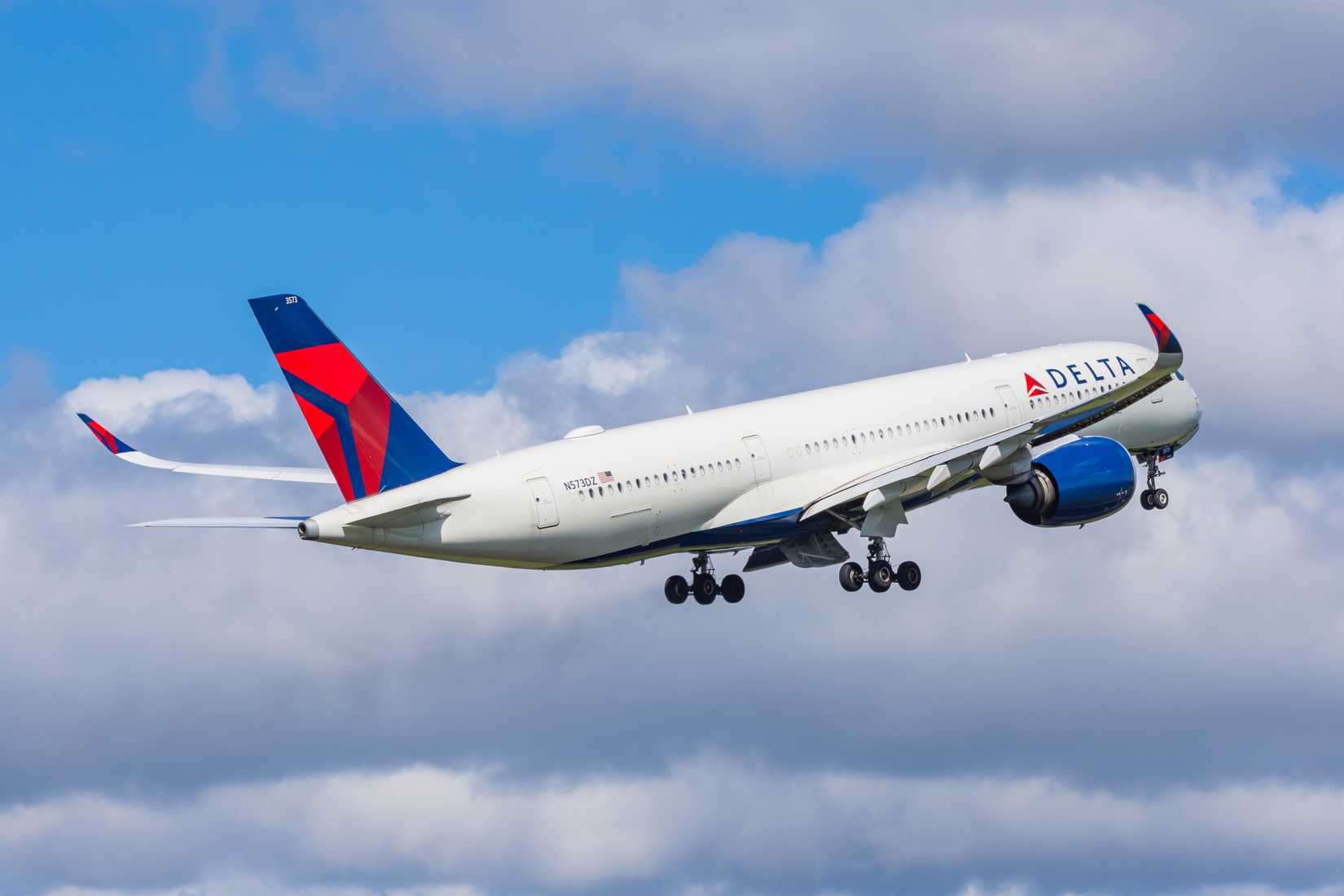 Delta Air Lines Airbus A350-900 takeoff blue sky and clouds