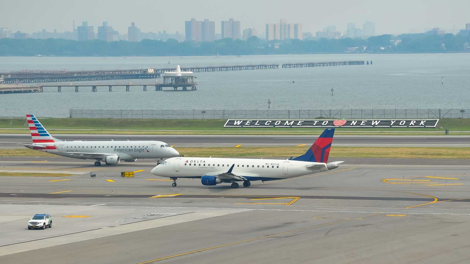Delta Airlines and American Eagle planes seen at the runway of LaGuardia International Airport