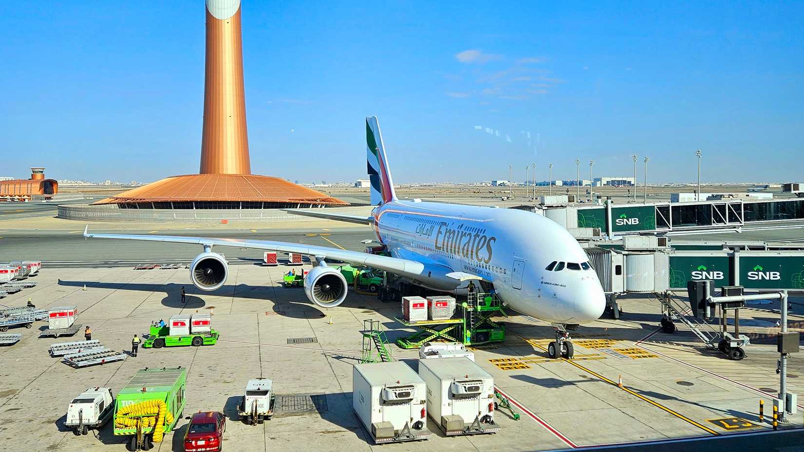 Emirates A380-800 with the air traffic control tower in the background at Jeddah Airport