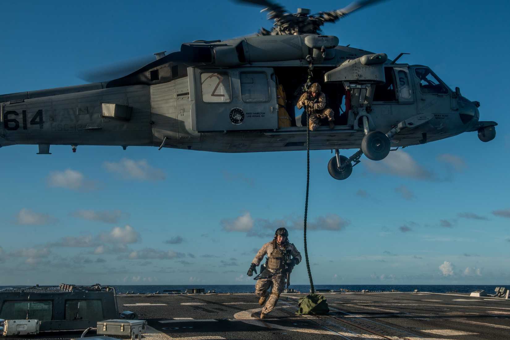 Explosive Ordnance Disposal Mobile Unit 5, Platoon 503 fast rope from a MH-60S Knighthawk of Helicopter Combat Squadron (HSC) 12