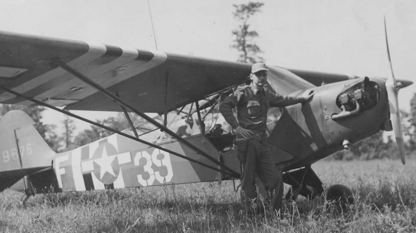 France-1st Lt. John J. Donnelan of New York, a pilot of a Piper L-4 %22Cub%22 in the artillery, flies over enemy lines spotting positions and relays them back to his units