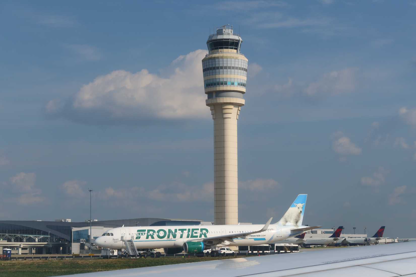Frontier Airlines aircraft and the control tower at Hartsfield-Jackson Atlanta International Airport