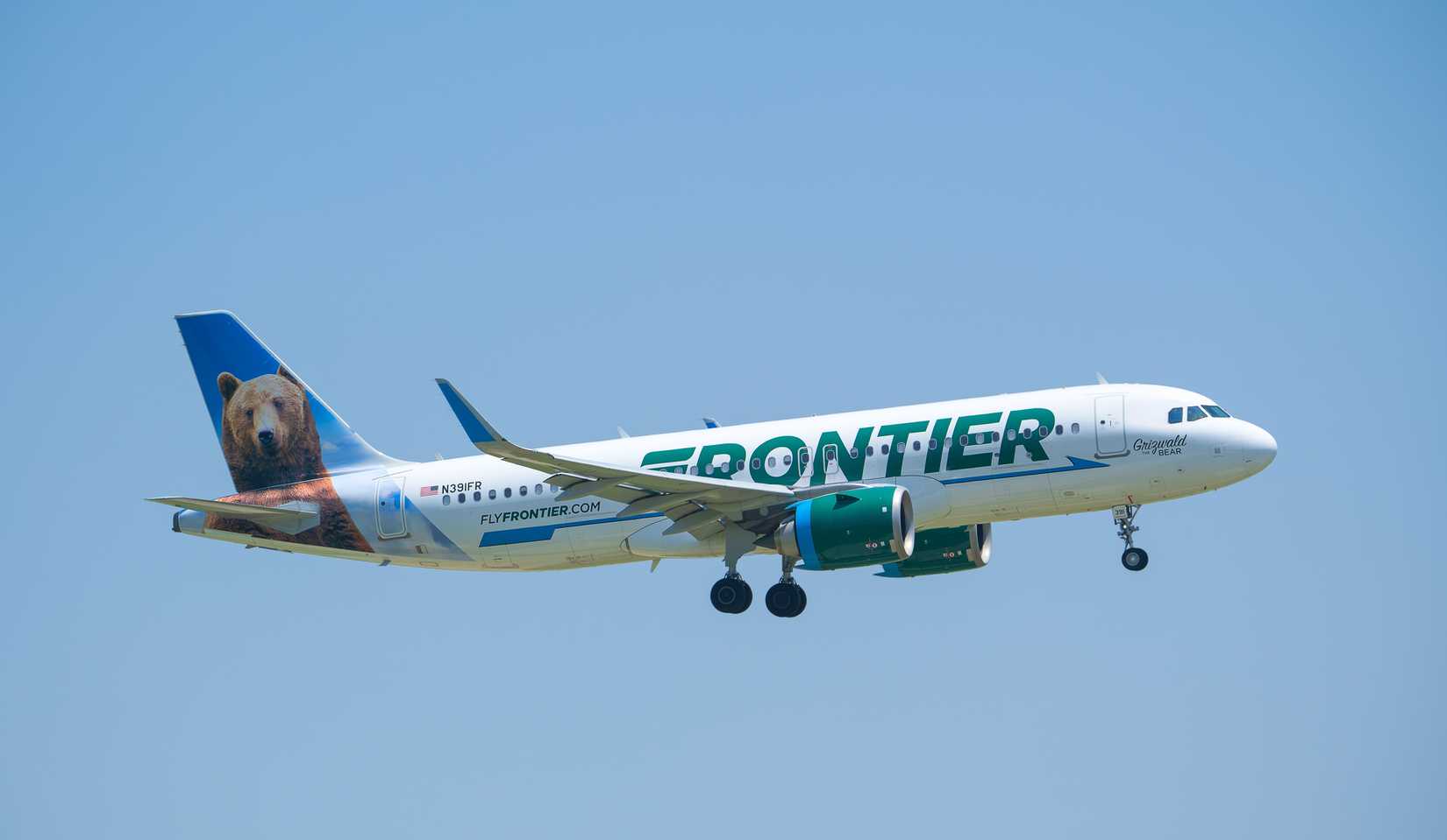 Frontier Airlines aircraft with blue sky background