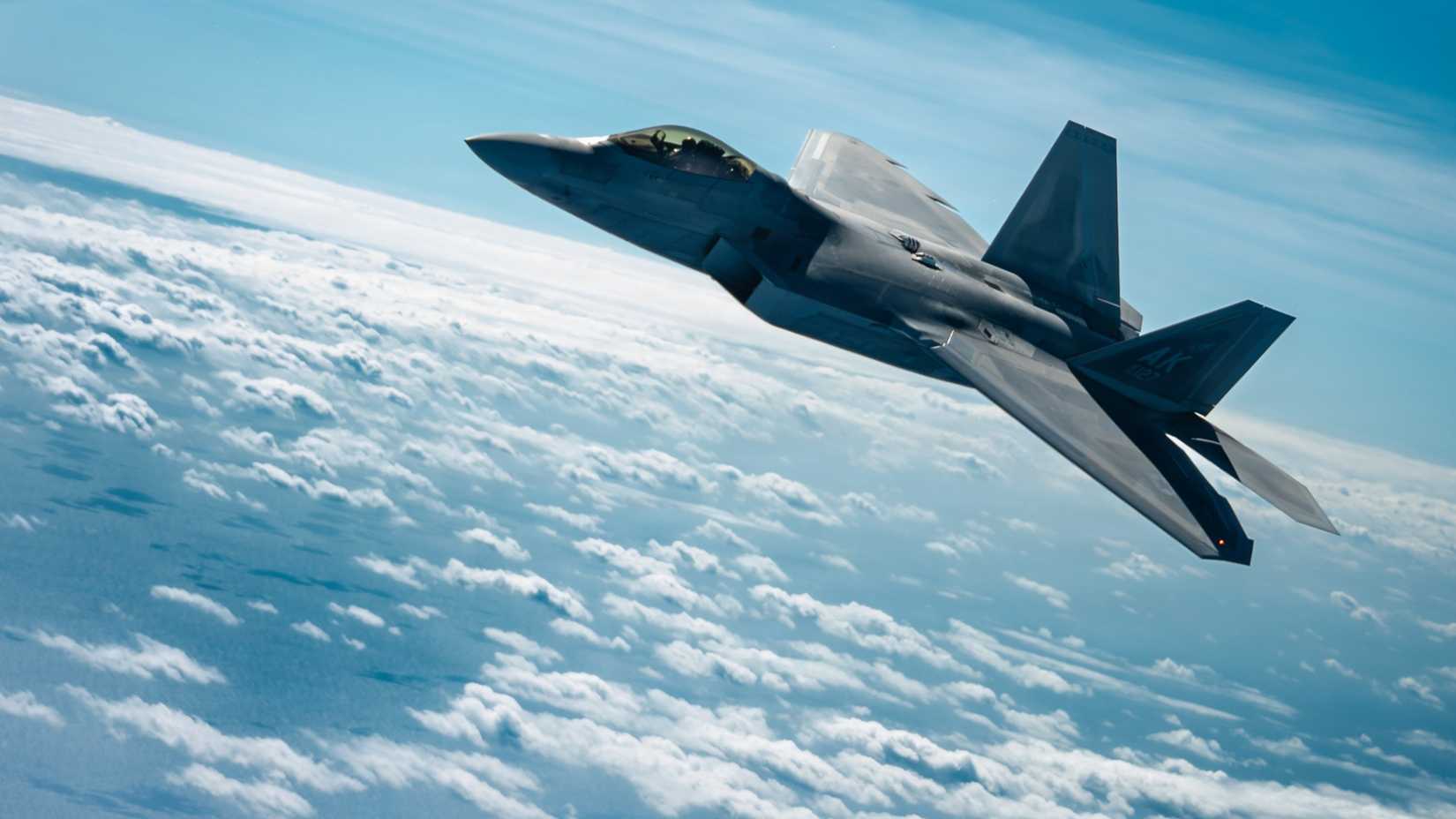 ir Force F-22 Raptor assigned to the 525th Expeditionary Fighter Squadron, deployed from Joint Base Elmendorf-Richardson, Alaska, flies alongside a KC-135 Stratotanker