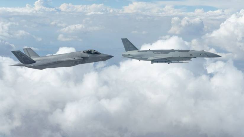 ir Force YFQ-44A Fury aircraft, right, assigned to the Collaborative Combat Aircraft Experimental Operations Unit, flies alongside an F-35 Lightning II