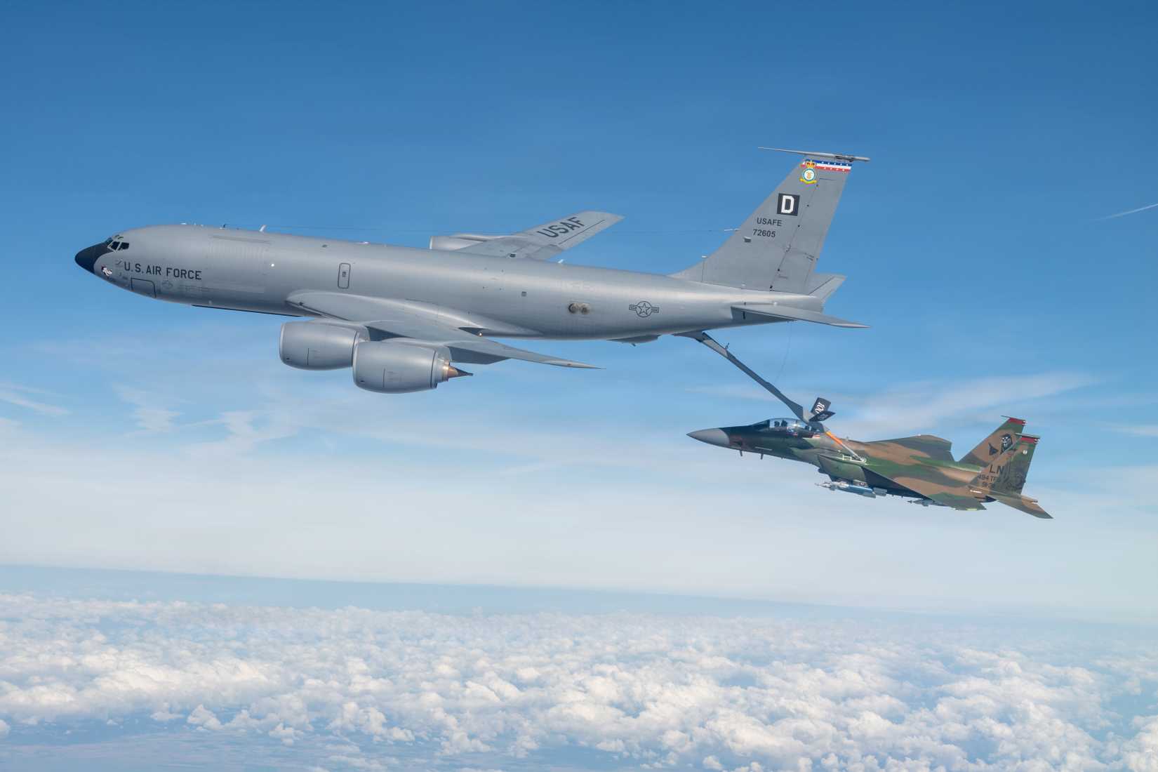 KC-135 Stratotanker, assigned to the 100th Air Refueling Wing, refuels an F-15E Strike Eagle aircraft, assigned to the 494th Fighter Squadron, above the United Kingdom